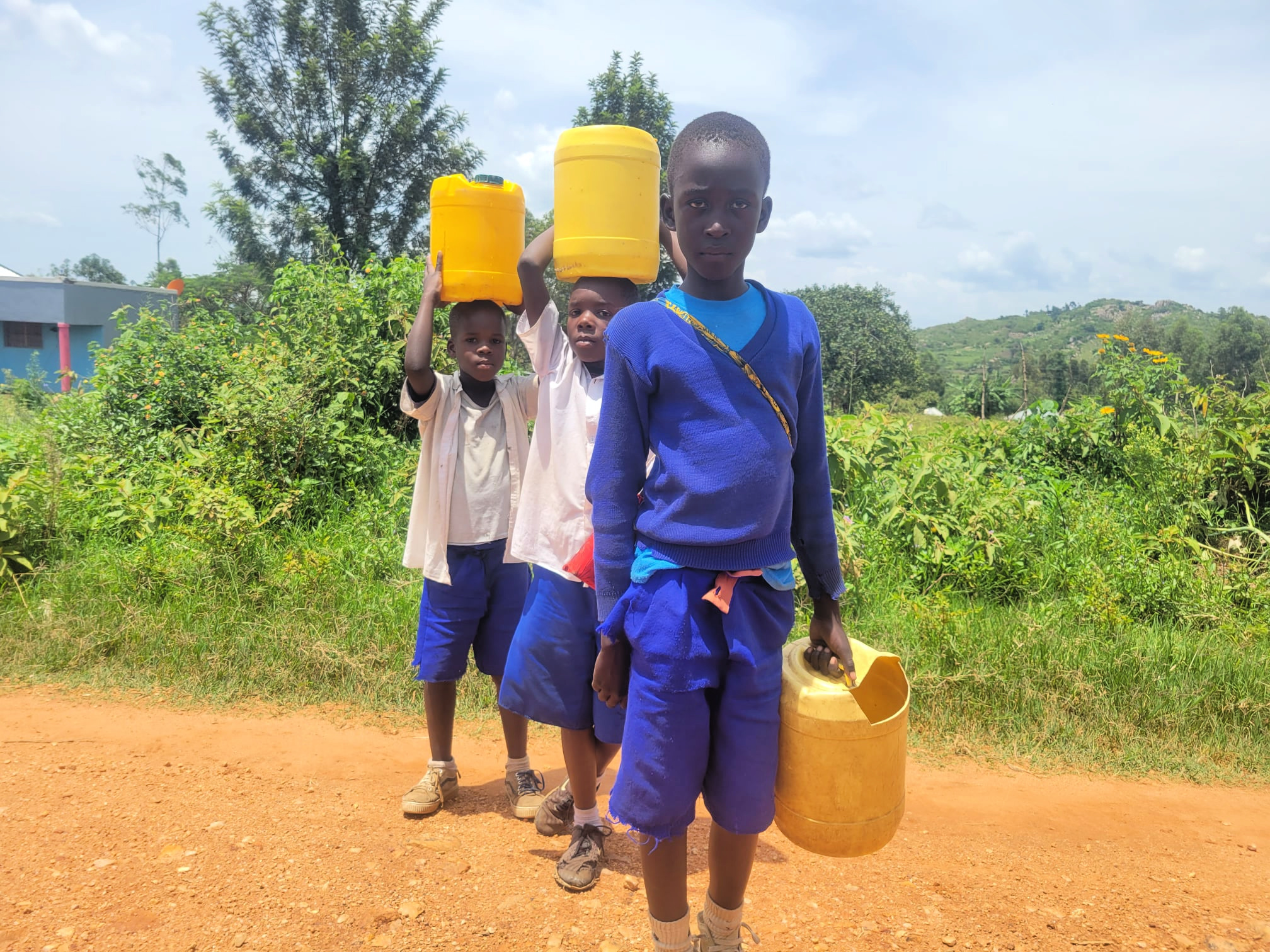Boys carrying water from a WaterStep community